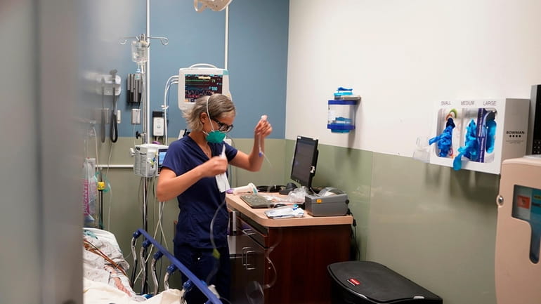 Registered nurse Sandra Younan sets up a new intravenous line...