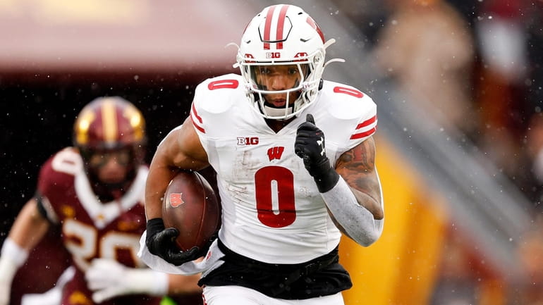 Braelon Allen #0 of the Wisconsin Badgers runs with the...