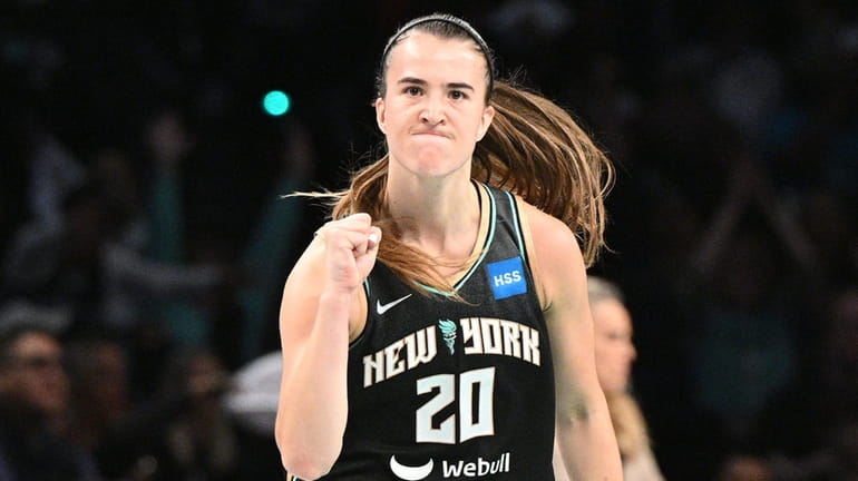 New York Liberty guard Sabrina Ionescu reacts after sinking a...