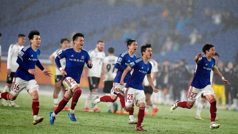 Players of Yokohama F. Marinos celebrate after a penalty kick...