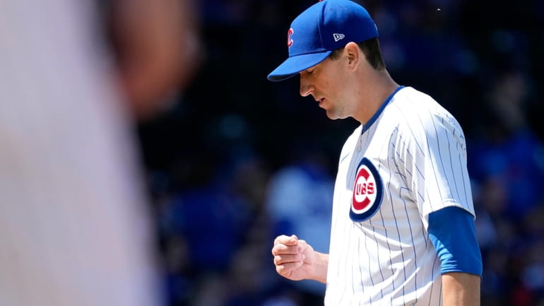 Chicago Cubs starting pitcher Kyle Hendricks looks down during the...