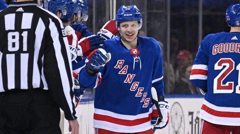 Rangers left wing Artemi Panarin is congratulated by teammates after...