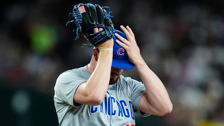 Chicago Cubs relief pitcher Luke Little pauses on the mound...