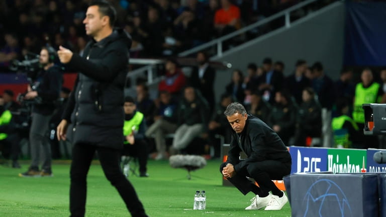 PSG's head coach Luis Enrique, right, and Barcelona's head coach...