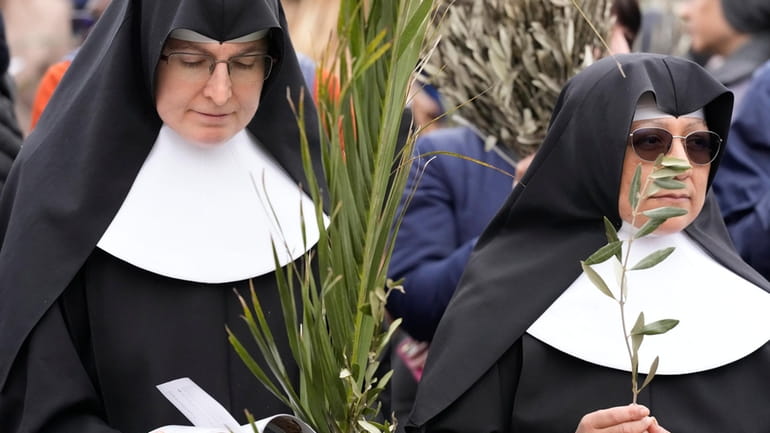 Nuns wait for the start of the Palm Sunday's mass...