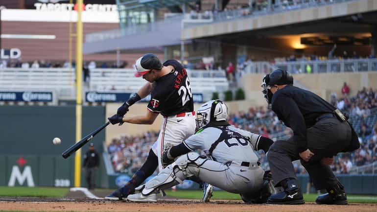 Minnesota Twins' Max Kepler (26) hits an RBI-double during the...
