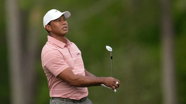 Tiger Woods watches his tee shot on the 12th hole...