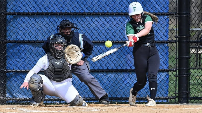 Ruby Seaman of Farmingdale drives one over the fence to...