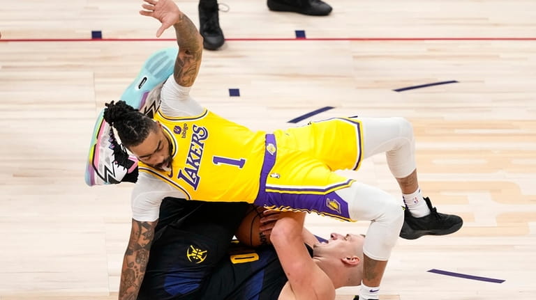 Los Angeles Lakers guard D'Angelo Russell (1) falls on Denver...
