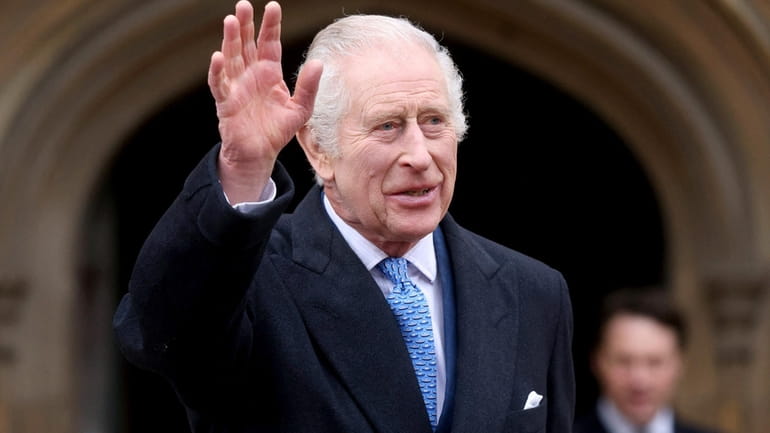 Britain's King Charles III waves as he leaves after attending...