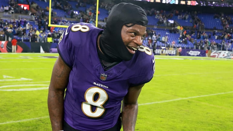 Quarterback Lamar Jackson #8 of the Baltimore Ravens celebrates after...
