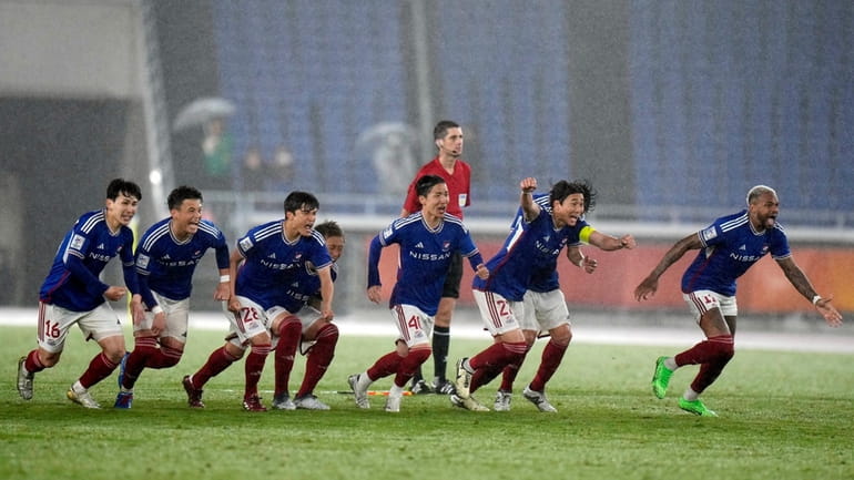 Players of Yokohama F. Marinos celebrate after a penalty kick...