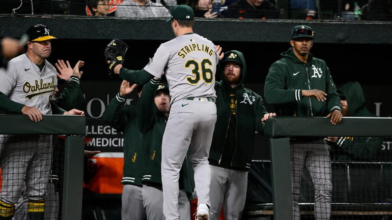 Oakland Athletics starting pitcher Ross Stripling (36) is greeted by...