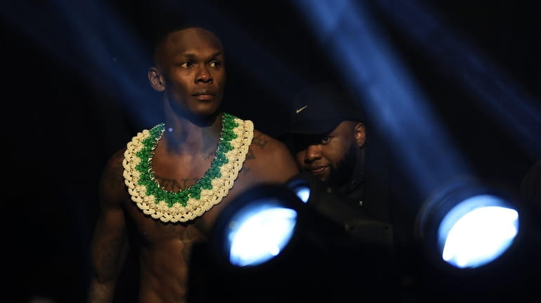 Israel Adesanya walks to the scale during the ceremonial weigh in...