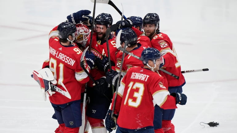 Florida Panthers players celebrate after beating the Tampa Bay Lightning...