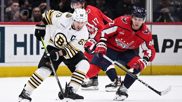 Boston Bruins left wing Brad Marchand (63) skates with the...