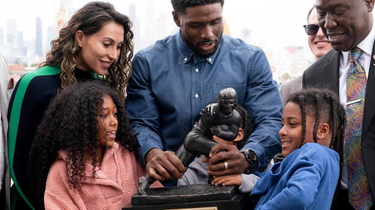 Former USC football player Reggie Bush with his family try...