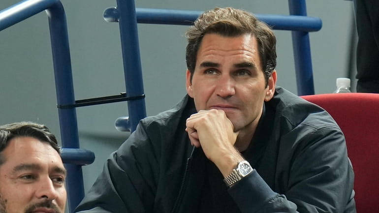 Retired tennis player Roger Federer watches the men's singles quarterfinal...