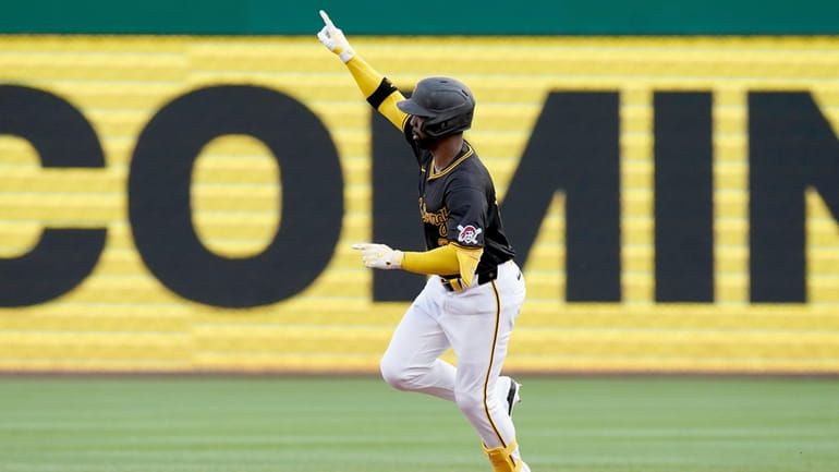 Pittsburgh Pirates' Andrew McCutchen runs the bases after hitting a...