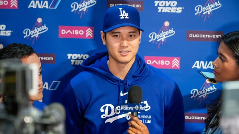 Los Angeles Dodgers' Shohei Ohtani speaks with reporters before a...