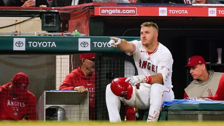 Los Angeles Angels' Mike Trout gestures while waiting to bat...