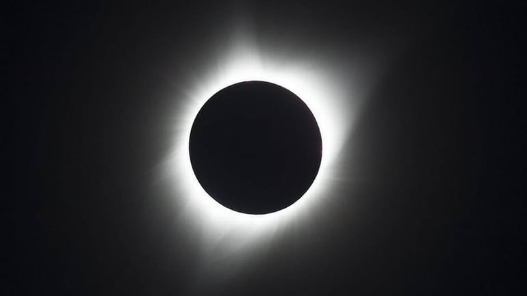 A total eclipse takes place when the moon passes between...