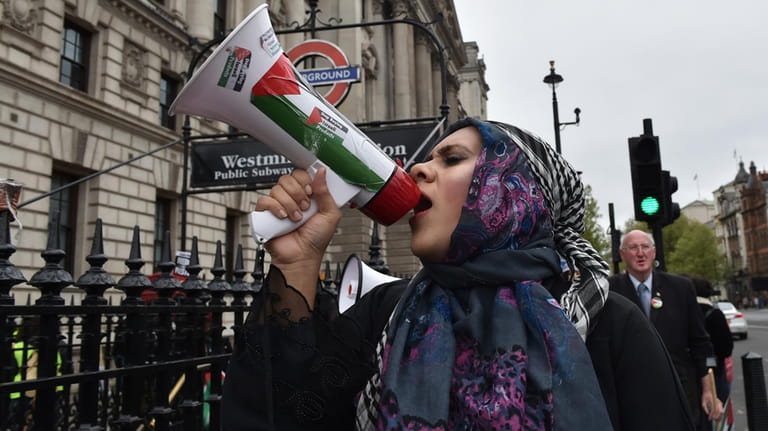 Pro-Palestinian protester holds a megaphone ahead of a march in...
