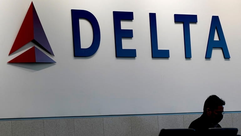 A man waits for a Delta Air Lines flight at...