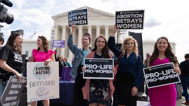 Anti-Abortion activists rally outside the Supreme Court, Wednesday, April 24,...