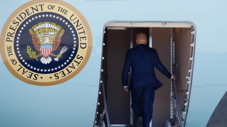 President Joe Biden boards Air Force One, March 11, 2024,...