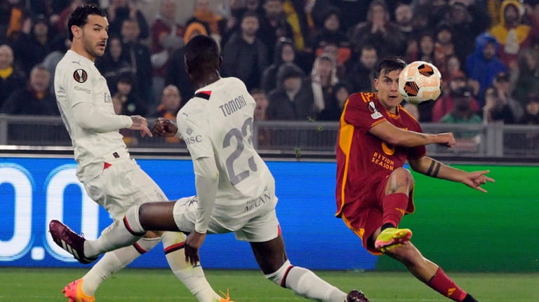 Roma's Paulo Dybala, right, scores their second goal during the...