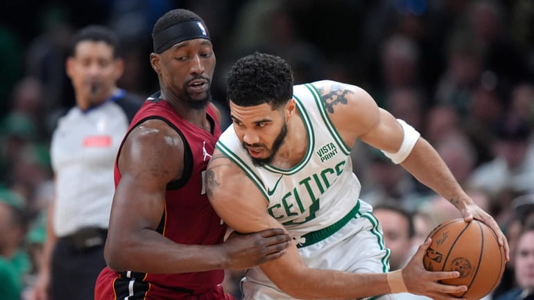 Miami Heat center Bam Adebayo, left, defends as Boston Celtics...