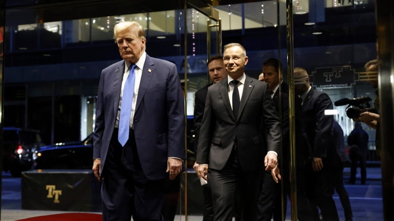 Republican presidential candidate former President Donald Trump walks with Poland's...