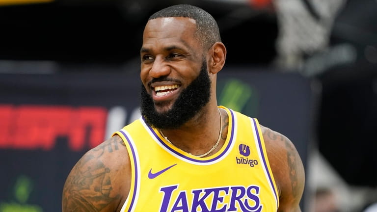 Los Angeles Lakers forward LeBron James smiles during the team's media...
