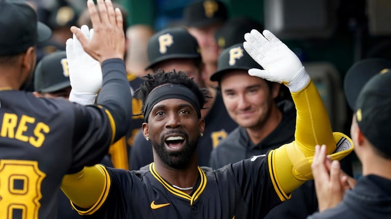 Pittsburgh Pirates' Andrew McCutchen celebrates in the dugout after hitting...