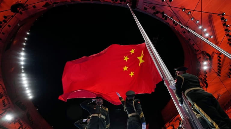 The Chinese national flag is raised during the opening ceremony...