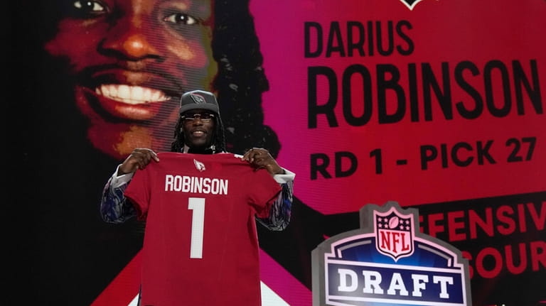Missouri defensive lineman Darius Robinson poses after being chosen by...