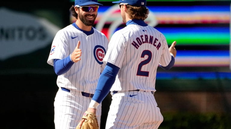 Chicago Cubs' Nico Hoerner (2) and Dansby Swanson celebrate the...