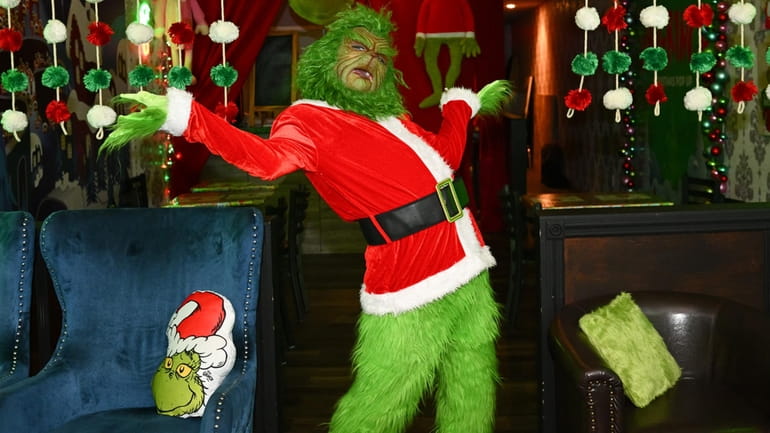 Charles Jacker as the Grinch strikes a pose at a...