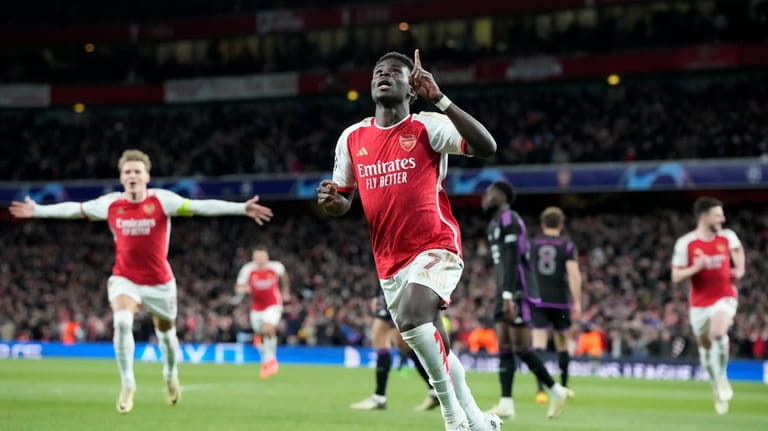 Arsenal's Bukayo Saka celebrates after he scored the opening goal...