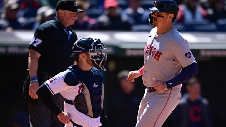 Boston Red Sox's Reese McGuire scores a run on an...