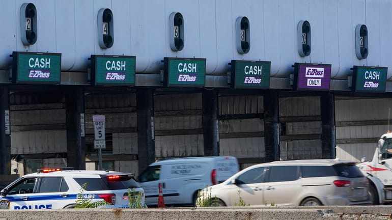 Cars pass through toll booths to use the George Washington...