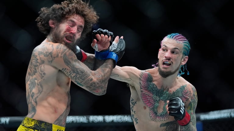 Sean O'Malley, right, lands a blow against Marlon Vera during...