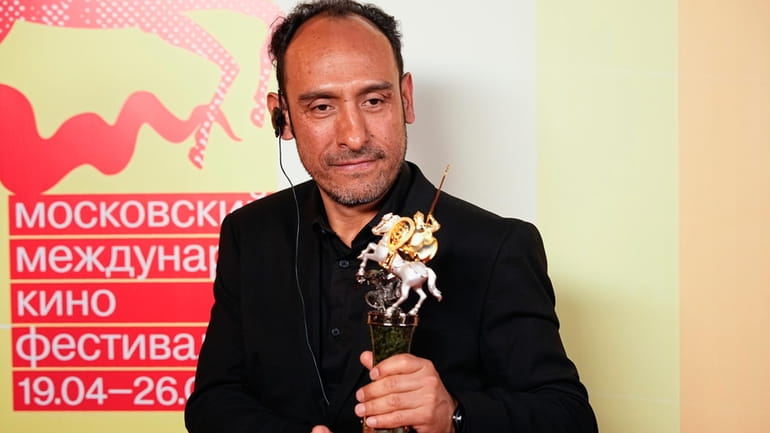 Mexican director Miguel Salgado poses with his the Golden Saint...