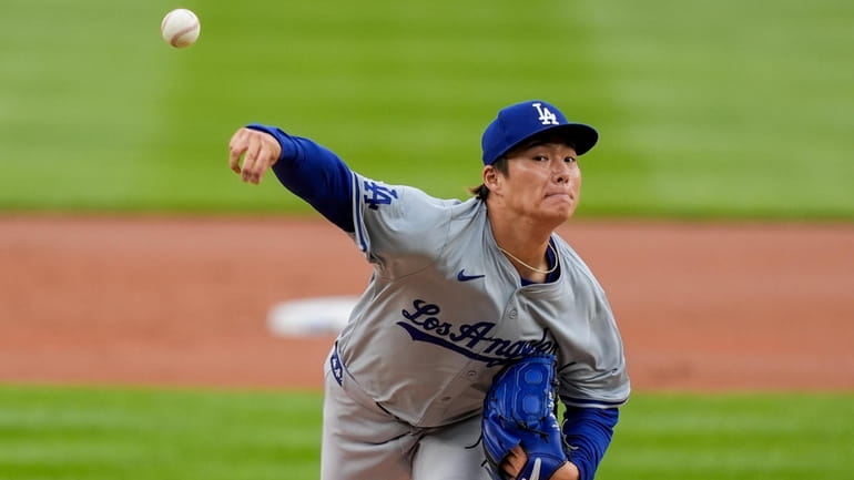 Los Angeles Dodgers starting pitcher Yoshinobu Yamamoto throws during the...