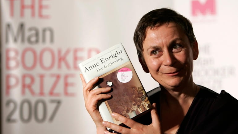 Irish writer Anne Enright holds a copy of her book...