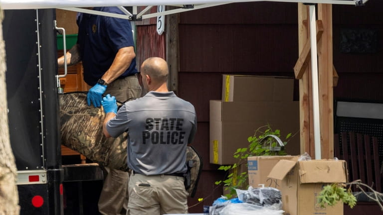 Police remove evidence from the Massapequa Park home of alleged Gilgo...