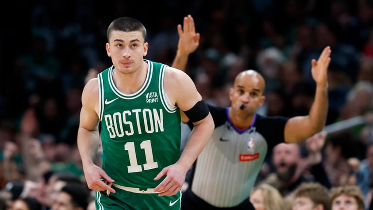 Boston Celtics' Payton Pritchard (11) heads up court after making...