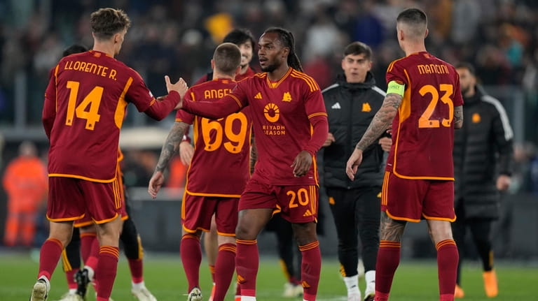 Players from Roma congratulate each other after their victory during...