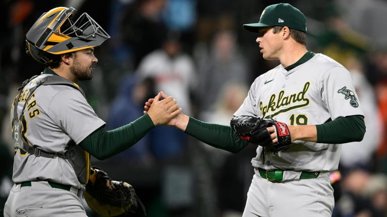 Oakland Athletics relief pitcher Mason Miller, right, celebrates with catcher...